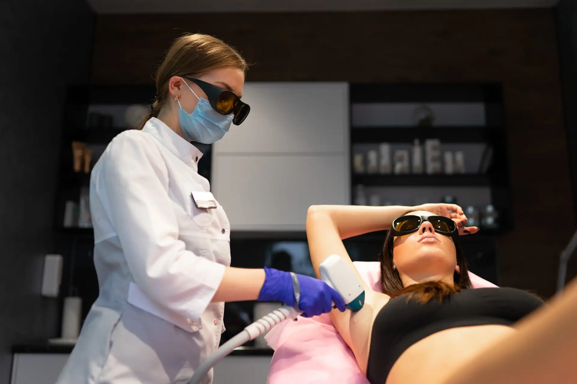Woman getting treated with laser hair removal in a medical spa