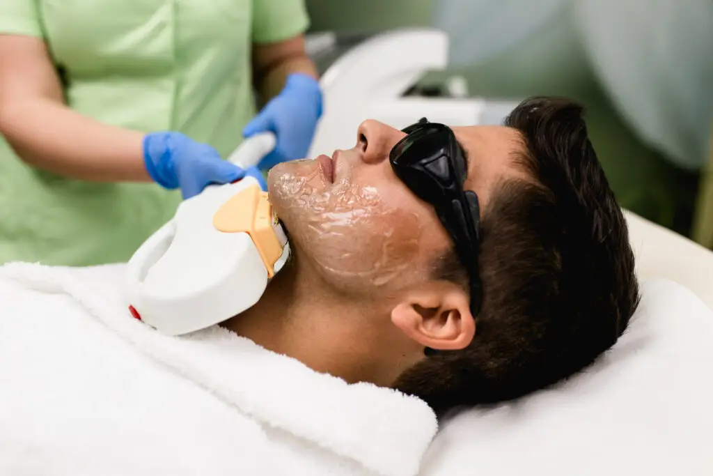 Young man getting laser hair removal in medical spa